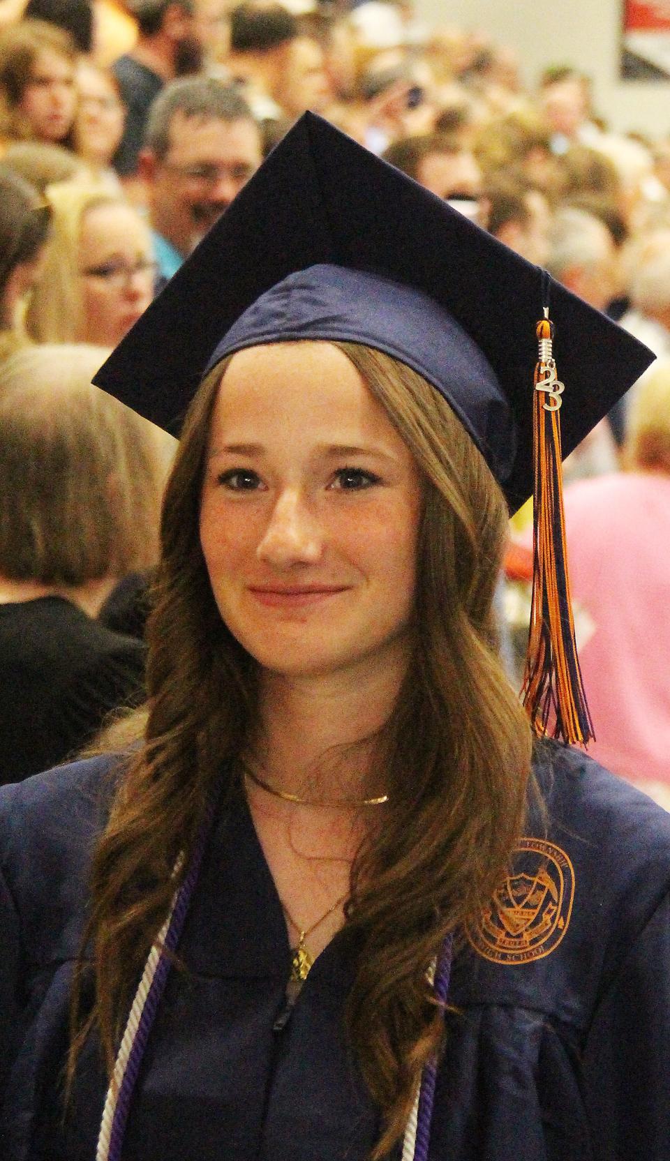 A proud graduate, Julie Godart smiles as she makes the recessional at the end of the Pontiac Township High School graduation ceremony on May 21.