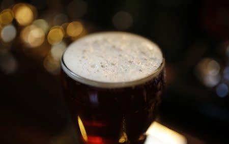 A pint of beer stands on a bar in a pub in Liverpool northern England November 19 , 2014. REUTERS/Phil Noble