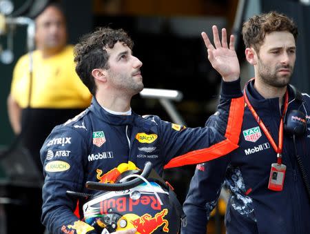 Formula One - F1 - Australian Grand Prix - Melbourne, Australia - 25/03/2017 Red Bull Racing driver Daniel Ricciardo of Australia waves to fans as he walks down pit lane after crashing out of the qualifying session. REUTERS/Brandon Malone