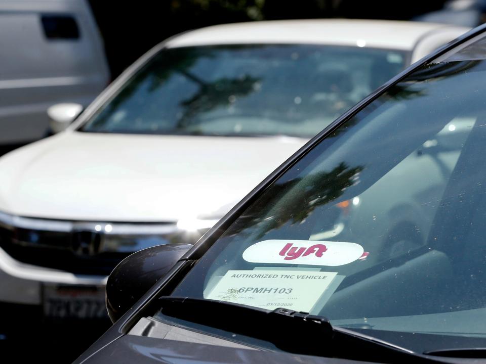 FILE - In this July 9, 2019, file photo a Lyft ride-share car waits at a stoplight in Sacramento, Calif. Ride-hailing service Lyft's annual loss more than doubled last year to over $2.6 billion, but the company claimed progress as revenue jumped 68% and ridership grew. (AP Photo/Rich Pedroncelli, File)