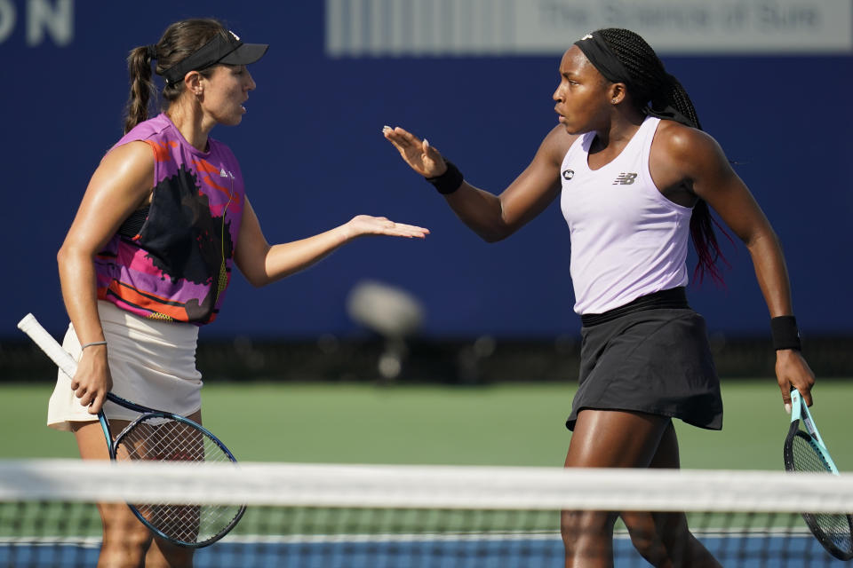 Coco Gauff, right, celebrates a point with partner Jessica Pegula during the doubles final against Gabriela Dabrowski, of Canada, and Giuliana Olmos, of Mexico, at the San Diego Open tennis tournament Sunday, Oct. 16, 2022, in San Diego. (AP Photo/Gregory Bull)