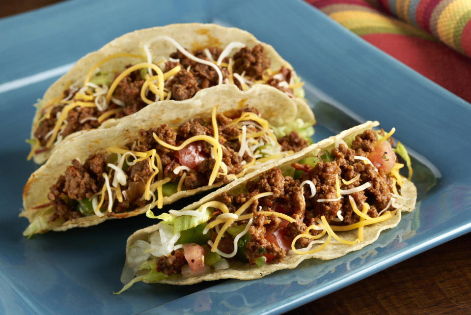 Hard tacos with ground beef, veggies, and cheese.