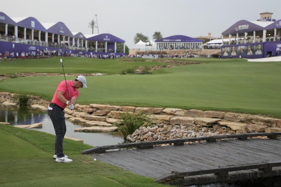 Rory McIlroy of Northern Ireland studies a shot on the 18th hole during the round one of the DP World Tour Championship golf tournament, in Dubai, United Arab Emirates, Thursday, Nov. 16, 2023. (AP Photo/Kamran Jebreili)