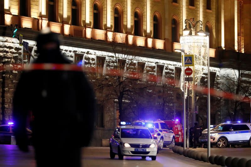 Police cars block a street near the Federal Security Service (FSB) building after a shooting incident, in Moscow