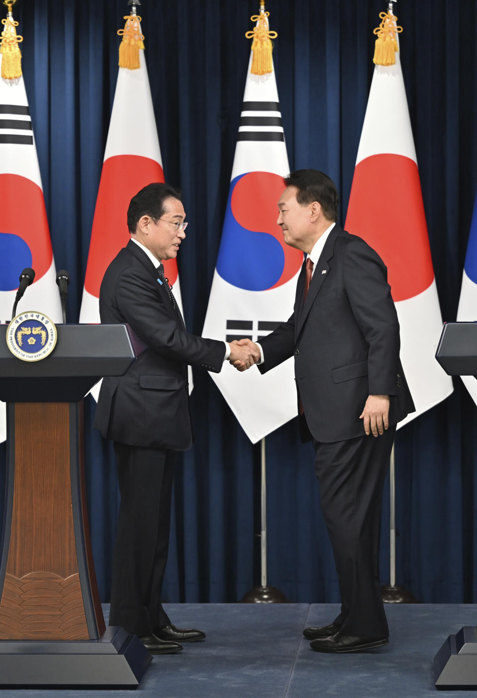 South Korean President Yoon Suk Yeol, right, shakes hands with Japanese Prime Minister Fumio Kishida during a joint press conference after their meeting at the presidential office in Seoul Sunday, May 7, 2023. The leaders of South Korea and Japan met Sunday for their second summit in less than two months, as they push to mend long-running historical grievances and boost ties in the face of North Korea’s nuclear program and other regional challenges. (Jung Yeon-je/Pool Photo via AP)