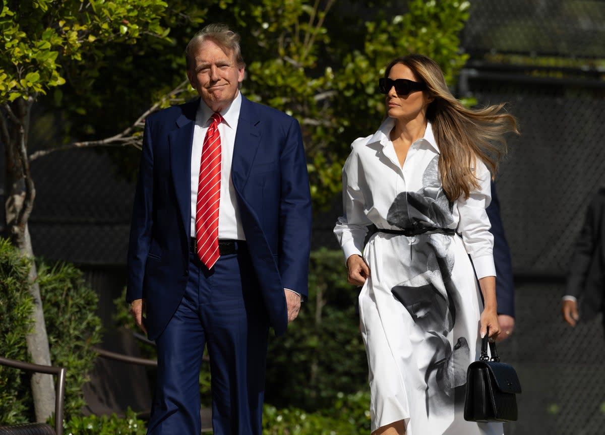 Former US President Donald Trump and former first lady Melania Trump walk together as they prepare to vote at a polling station in Florida (Getty Images)