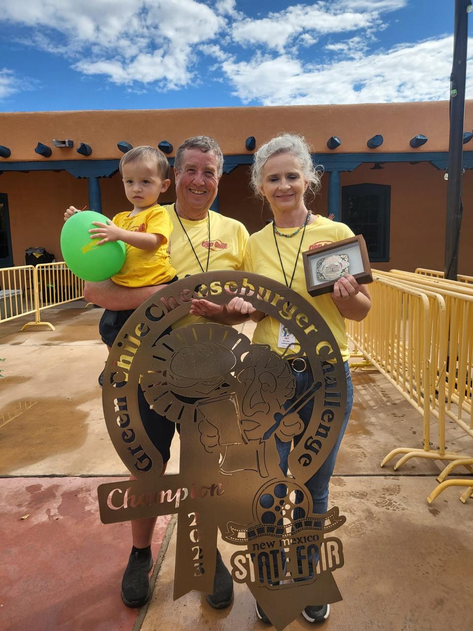 Brian and Pam Cleckler with their grandson and the People's Choice Award and Judges Award from the 2023 New Mexico State Fair.