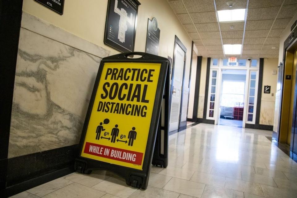 Signs encouraging social distancing inside the State House.