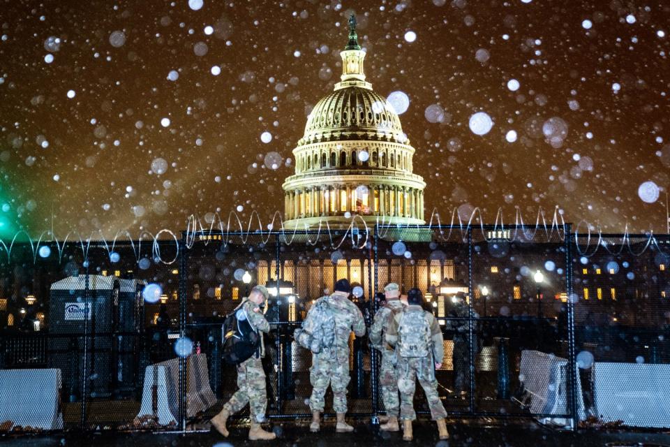 Snow falls over the U.S. Capitol.