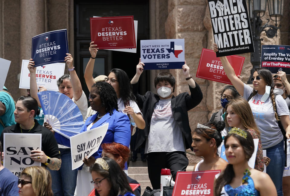 Demonstrators join a rally to protest proposed voting bills on the steps of the Texas Capitol, Tuesday, July 13, 2021, in Austin, Texas. Texas Democrats left the state to block sweeping new election laws, while Republican Gov. Greg Abbott threatened them with arrest the moment they return. (AP Photo/Eric Gay)