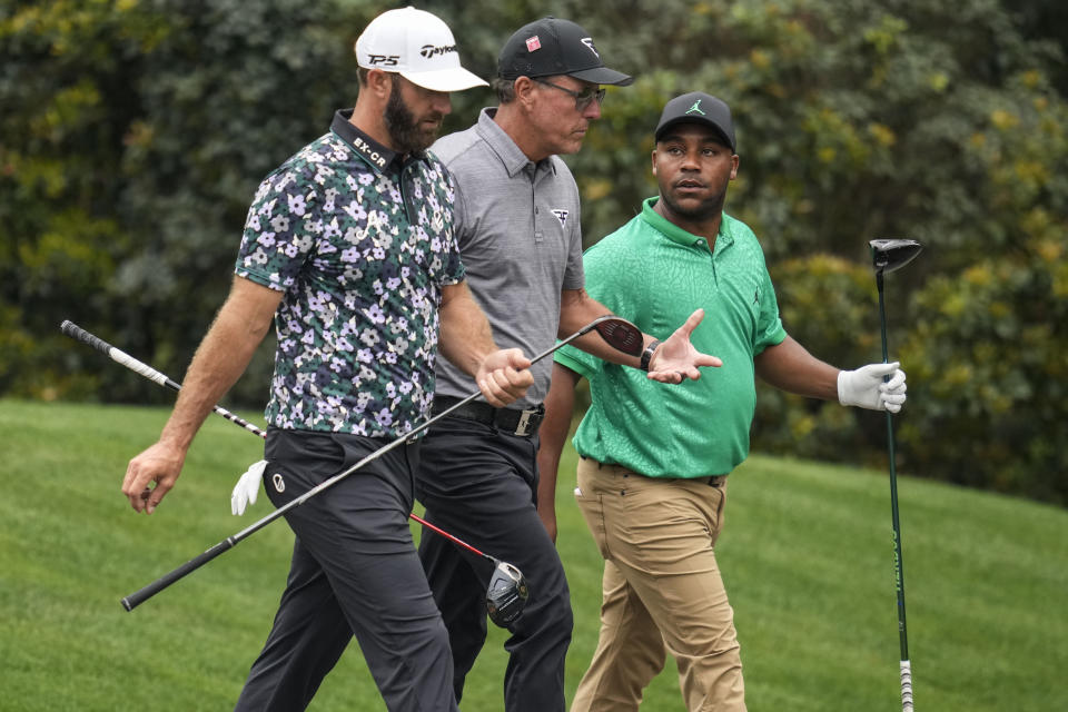 Dustin Johnson, Phil Mickelson, and Harold Varner III, walks in the 11th fairway during a practice for the Masters golf tournament at Augusta National Golf Club, Tuesday, April 4, 2023, in Augusta, Ga. (AP Photo/Mark Baker)