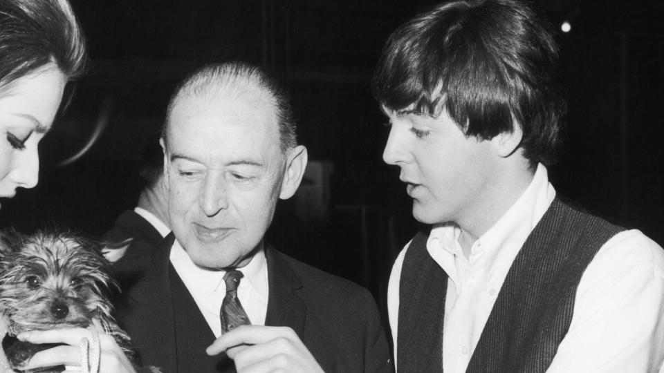 Paul McCartney with father Jim McCartney and actress Magda Konopka, pictured during break in filming, on set, Twickenham, Middlesex. Shooting for 'A Hard Day's Night', 12th March 1964. a.k.a. James McCartney