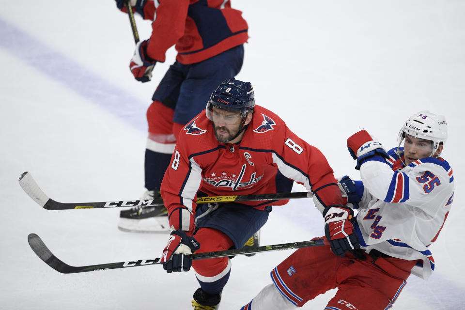 Washington Capitals left wing Alex Ovechkin (8) hits New York Rangers defenseman Ryan Lindgren (55) during the second period of an NHL hockey game, Sunday, March 28, 2021, in Washington. (AP Photo/Nick Wass)