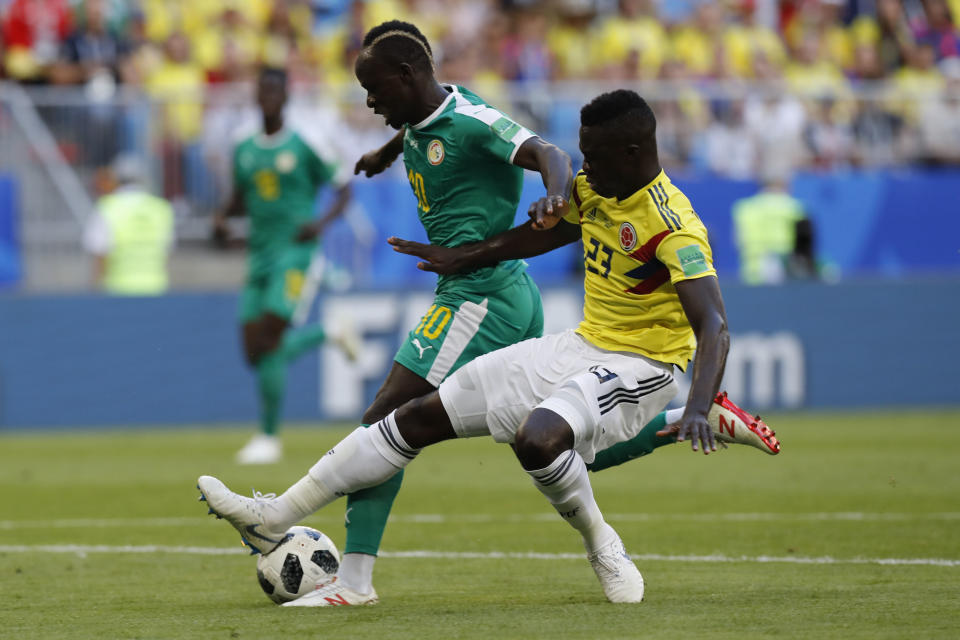 <p>Davinson Sanchez brings down Sadio Mane for a Senegal penaty, but it was correctly overtuned on VAR </p>