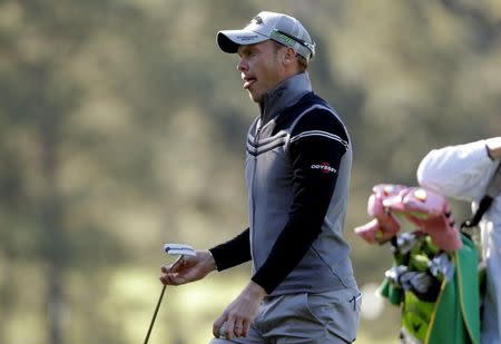 Danny Willett of England reacts as he walks off the third green in second round play during the 2017 Masters golf tournament at Augusta National Golf Club in Augusta, Georgia, U.S., April 7, 2017. REUTERS/Jonathan Ernst