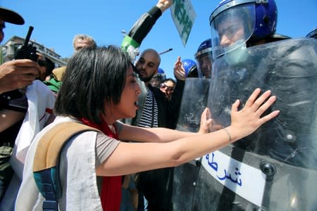 FILE PHOTO: Police officers prevent demonstrators from marching during a May Day protest on Labour Day in Algiers