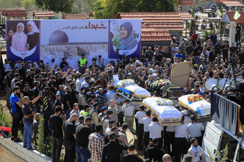 People carry the coffins of the victims who were killed by an Israeli airstrike, during their funeral procession in the town of Blida, a Lebanese border village with Israel in south Lebanon, Tuesday, Nov. 7, 2023. A Lebanese woman and her three grand daughters were laid to rest in their hometown in southern Lebanon two days after they were killed in an Israeli drone strike while in a car near the Lebanon-Israel border. (AP Photo/Mohammed Zaatari)