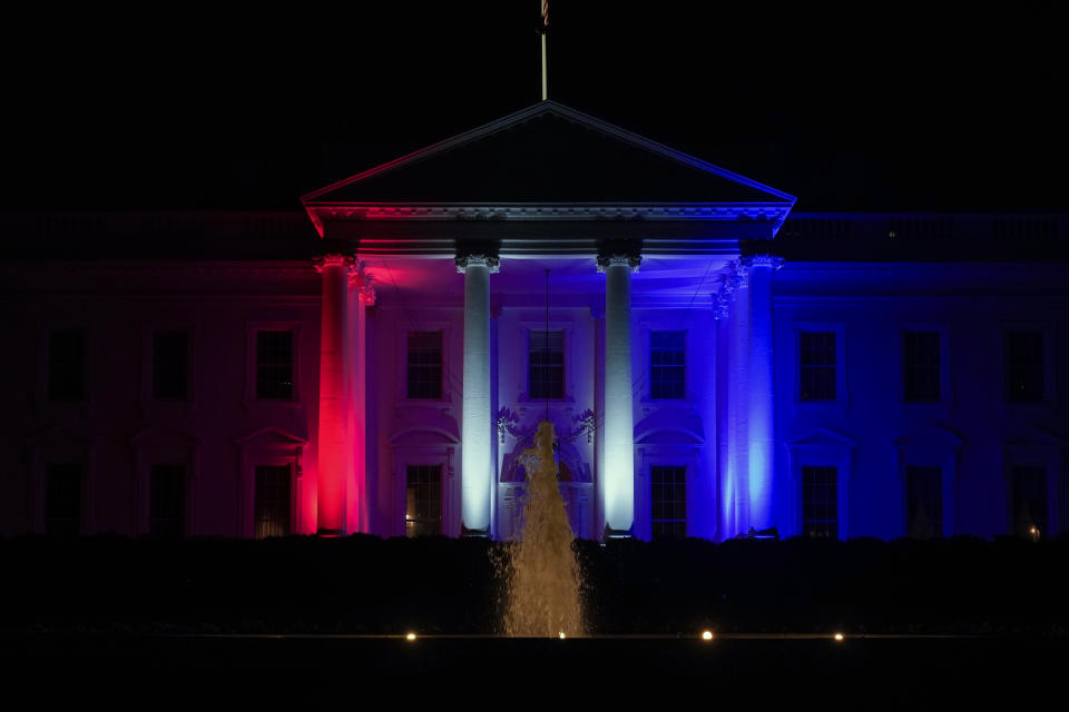 The White House is lit red, white and blue on Friday, July 23, 2021, in Washington for the the 2020 Summer Olympics in Japan. (AP Photo/Andrew Harnik)