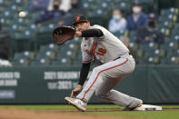 Baltimore Orioles first baseman Trey Mancini fields the ball on a ground out by Seattle Mariners' Kyle Lewis during the second inning of a baseball game, Tuesday, May 4, 2021, in Seattle. (AP Photo/Ted S. Warren)