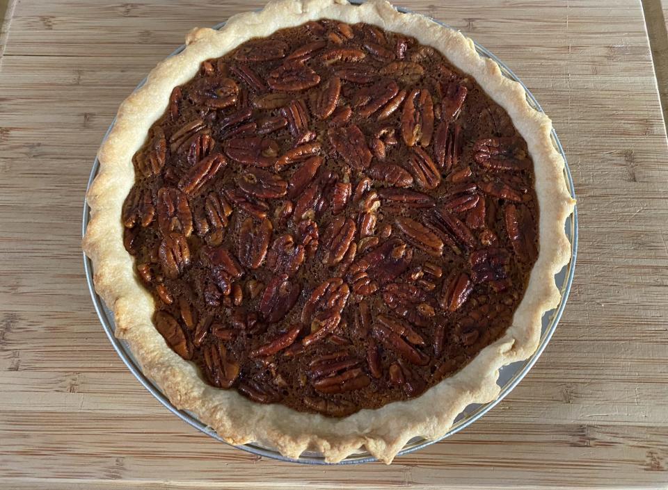 ina garten's maple pecan pie on a kitchen cutting board