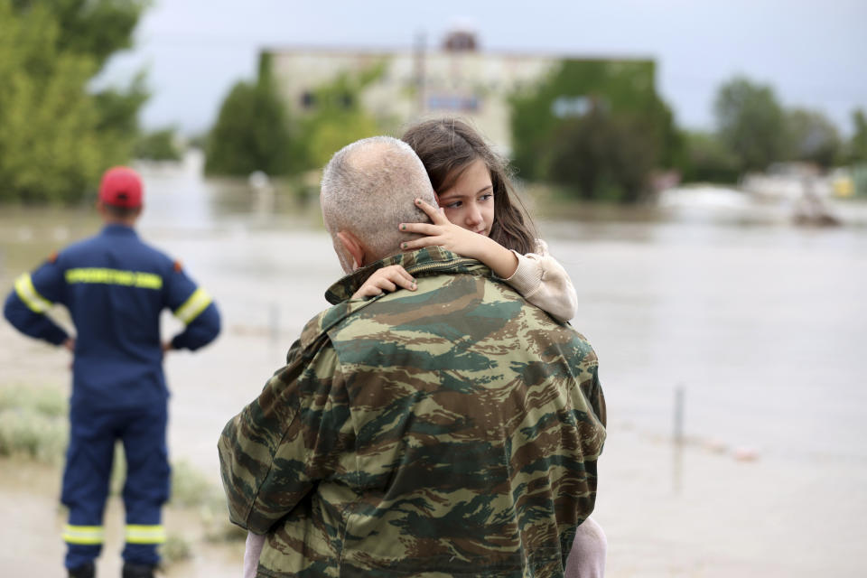 Ilias Chatziliadis holds his daughter Georgia after firefighters helped her evacuate a flooded building in Larissa, central Greece, Wednesday, Sept. 6, 2023. Fierce rainstorms are battering neighboring Greece, Turkey and Bulgaria, causing at least seven deaths.Fierce rainstorms are battering neighboring Greece, Turkey and Bulgaria, causing several deaths.elis Kousioras)