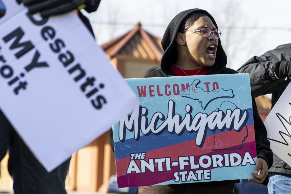 Protestors gather near the Great Hall Convention Center after Florida Governor Ron DeSantis delivered a speech at a Midland County Republican Party breakfast in Midland, Mich., on Thursday, April 6, 2023. DeSantis visited the central Michigan community for a county GOP event Thursday before heading to speak at Hillsdale College. (Kaytie Boomer/The Bay City Times via AP)