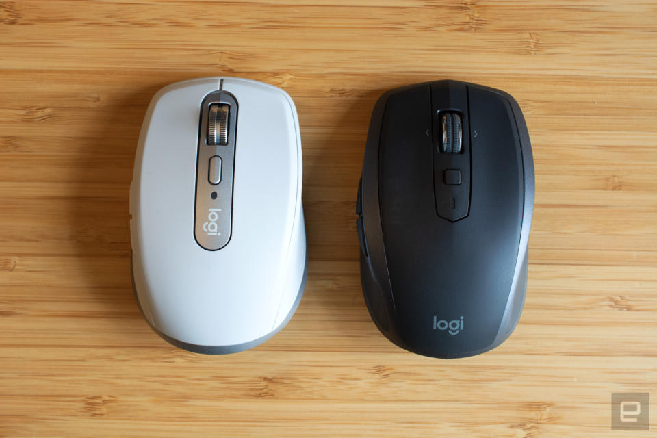 The Logitech MX Anywhere 3 mouse (left) next to the Logitech MX Anywhere 2s mouse (right) on a wooden table.