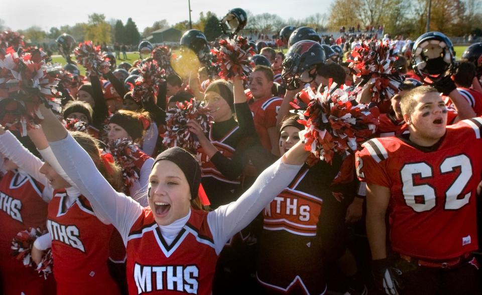 Metamora cheerleaders and players sing the school song Saturday after the Redbirds' second-round playoff victory over Mt. Zion.