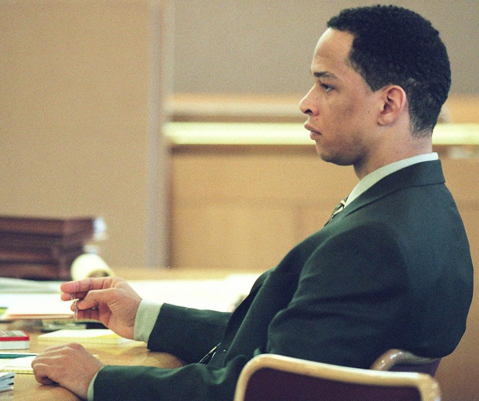 FILE - In this Jan. 3, 2001, file photo, former Carolina Panthers NFL football player Rae Carruth sits at the defense table during his trial in Charlotte, N.C. Former NFL wide receiver Rae Carruth has been released from prison after serving 18 years for conspiring to murder the mother of his unborn child. The Carolina Panthers’ 1997 first-round draft pick was released Monday, Oct. 22, 2018, from Sampson Correctional Institution in Clinton, North Carolina after completing his sentence. (AP Photo/Jeff Siner, Pool, File)