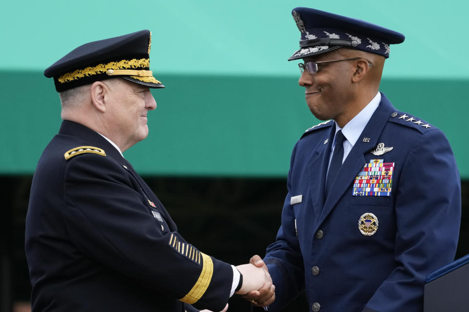 Retiring Chairman of the Joint Chiefs of Staff Gen. Mark Milley, left, shakes hands with Gen. CQ Brown, Jr., the incoming chairman, right, during the Armed Forces Farewell Tribute in honor of Milley at Joint Base Myer-Henderson Hall, Friday, Sept. 29, 2023, in Fort Meyer, Va. (AP Photo/Manuel Balce Ceneta)