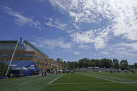 The 12 flag flies as Seattle Seahawks players take part in NFL football practice under blue skies Wednesday, July 28, 2021, in Renton, Wash. (AP Photo/Ted S. Warren)