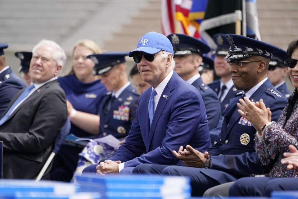 President Joe Biden listens during the 2023 United States Air Force Academy Graduation Ceremony at Falcon Stadium, Thursday, June 1, 2023, at the United States Air Force Academy in Colorado Springs, Colo. Air Force Chief of Staff Gen. CQ Brown, Jr., sits to the right of the President. (AP Photo/Andrew Harnik)