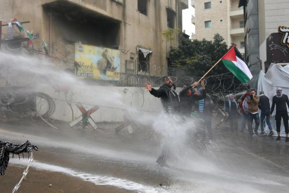 Lebanese security forces use a water hose to disperse protestors during a demonstration outside the US embassy (AFP/Getty Images)