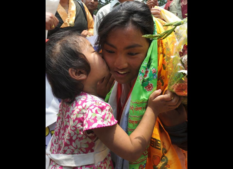 Nepalese young climber Nima Chemji Sherpa is welcomed by family and friends on her arrival at Tribhuvan domestic airport after summiting Mount Everest, in Kathmandu on May 25, 2012.  Nima Chemji reached Everest summit on 19 May 2012 and she claims to be the youngest woman ever to scale Mount Everest. (PRAKASH MATHEMA/AFP/GettyImages)