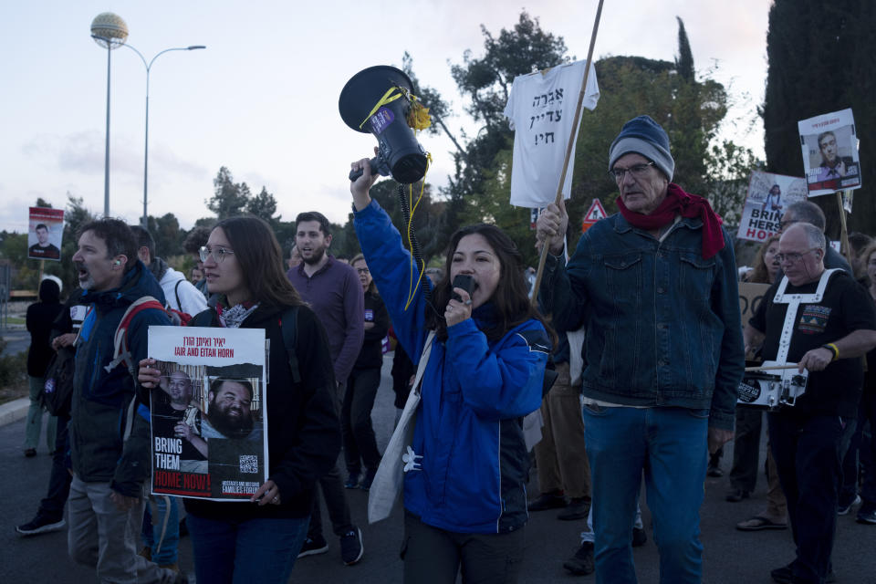 Relatives of hostages held in Gaza and their supporters move into an intersection to protest outside of the Prime Minister's office to call for an immediate release of the captives for the Jewish holiday of Passover as the war cabinet meets in Jerusalem, Tuesday, April 9, 2024. (AP Photo/Maya Alleruzzo)