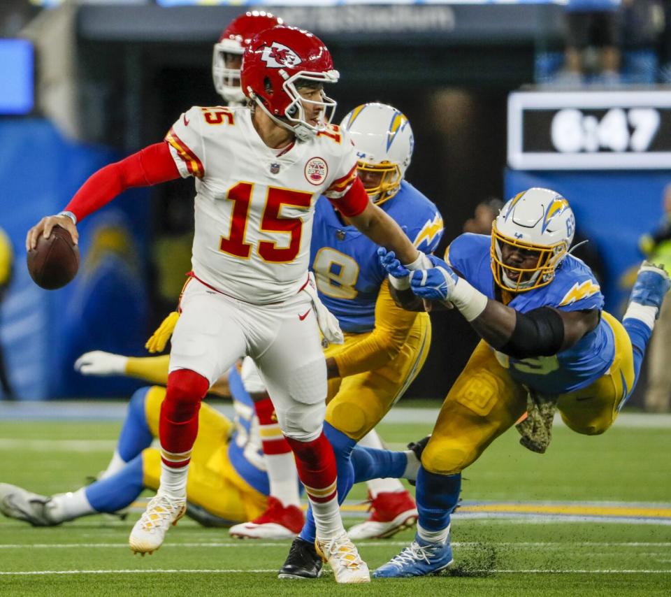 Chiefs quarterback Patrick Mahomes (15) tries to escape the grasp of Chargers defensive tackle Sebastian Joseph-Day (69).