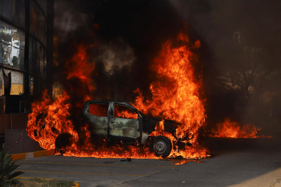 Vehicles burn, after students from Ayotzinapa Teacher Training College threw petrol bombs at the facilities of Guerrero Government's Palace, during a protest to demand justice for their slain colleague Yanqui Kothan Gomez, in Chilpancingo, Mexico, April 8, 2024. / Credit: Oscar Guerrero / REUTERS