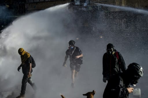 Demonstrators clash with the police during Monday night's protest in Santiago