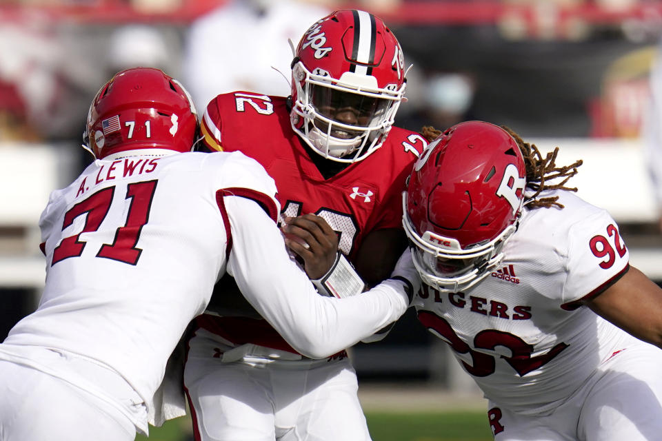 FILE - Maryland quarterback Lance LeGendre (12) is sacked by Rutgers defensive linemen Aaron Lewis (71) and Mayan Ahanotu (92) during the first half of an NCAA college football game, Saturday, Dec. 12, 2020, in College Park, Md. (AP Photo/Julio Cortez, File)