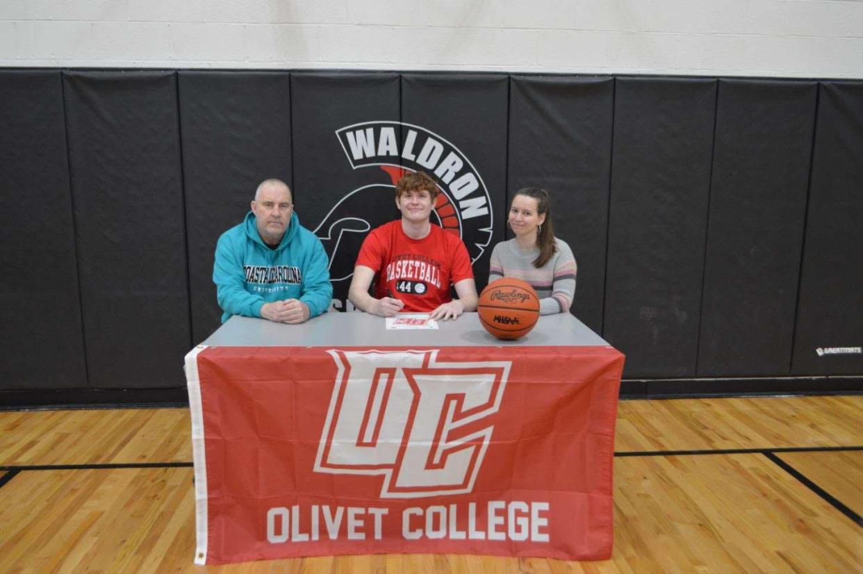 Senior Spartan Laiken Barnes signs his letter of intent to join the Olivet College basketball team.