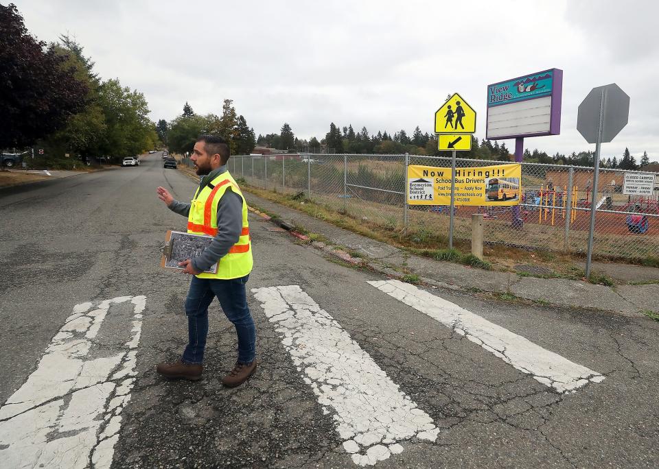 City of Bremerton project manager Nick Ataie talks about the upcoming sidewalk project as he crosses the 33rd and Spruce intersection at the entrance to View Ridge Elementary School on Friday.