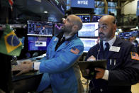 Specialist Meric Greenbaum, left, and trader Fred DeMarco work on the floor of the New York Stock Exchange, Friday, Nov. 15, 2019. Stocks are opening broadly higher on Wall Street as hopes continued to grow that the U.S. and China were moving closer to a deal on trade. (AP Photo/Richard Drew)