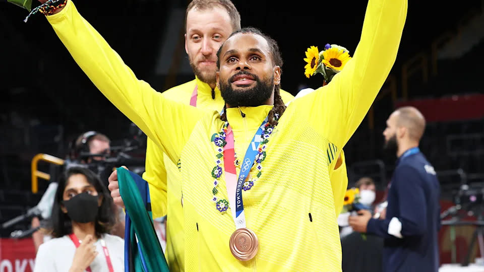 Seen here, Patty Mills celebrates after helping the Boomers claim a historic medal at the Olympics. 