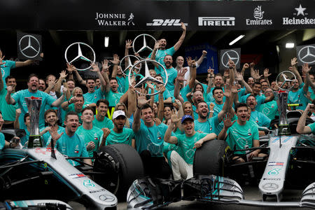 FILE PHOTO: Formula One F1 - Brazilian Grand Prix - Autodromo Jose Carlos Pace, Interlagos, Sao Paulo, Brazil - November 11, 2018 Mercedes' Lewis Hamilton, Mercedes' Valtteri Bottas, Executive Director Toto Wolff and team members pose after winning the constructors championship REUTERS/Ricardo Moraes/File Photo