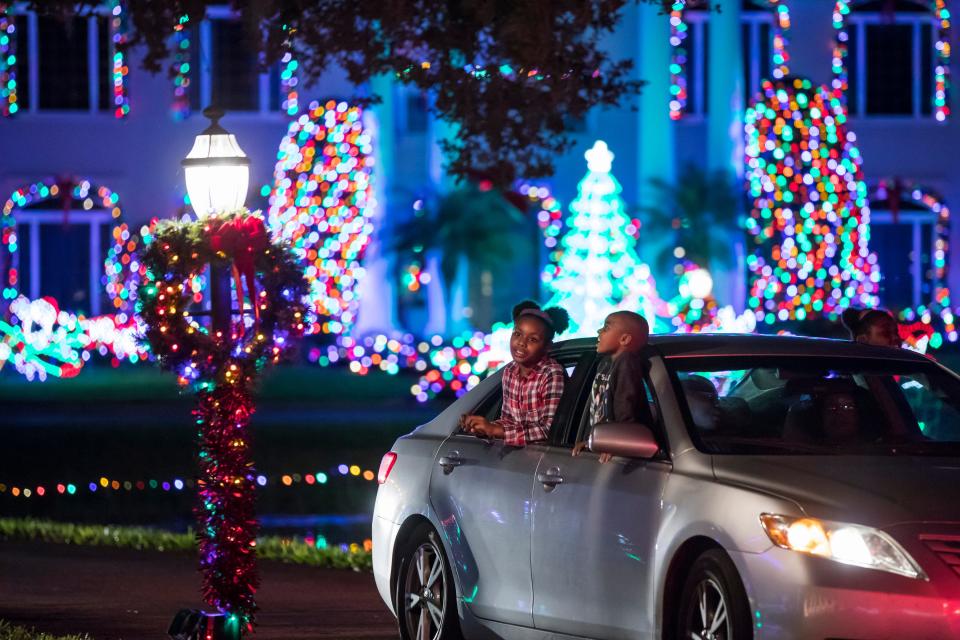 Alfrena Frazier (back left), 9, her brother Jasiah (center), 4, and sister Jazelyn, 8, look out of their car as they drive through Christmas at Tara light display on Tuesday, December 18, 2018, in Indian River County. The annual display, featuring hundreds of thousands of lights, draws thousands of visitors every year. It is free to drive through the site, which is open 5:30-10 p.m. Sundays-Thursdays and 5:30-11 p.m. Fridays and Saturdays through Dec. 31 at 7555 20th St., west of Vero Beach.