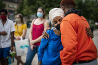 Rep. Ilhan Omar, second from right, D-Minn., greets a young voter outside the Dinkytown Target near the University of Minnesota campus in Minneapolis on Tuesday, Aug. 11, 2020. (Leila Navidi/Star Tribune via AP)