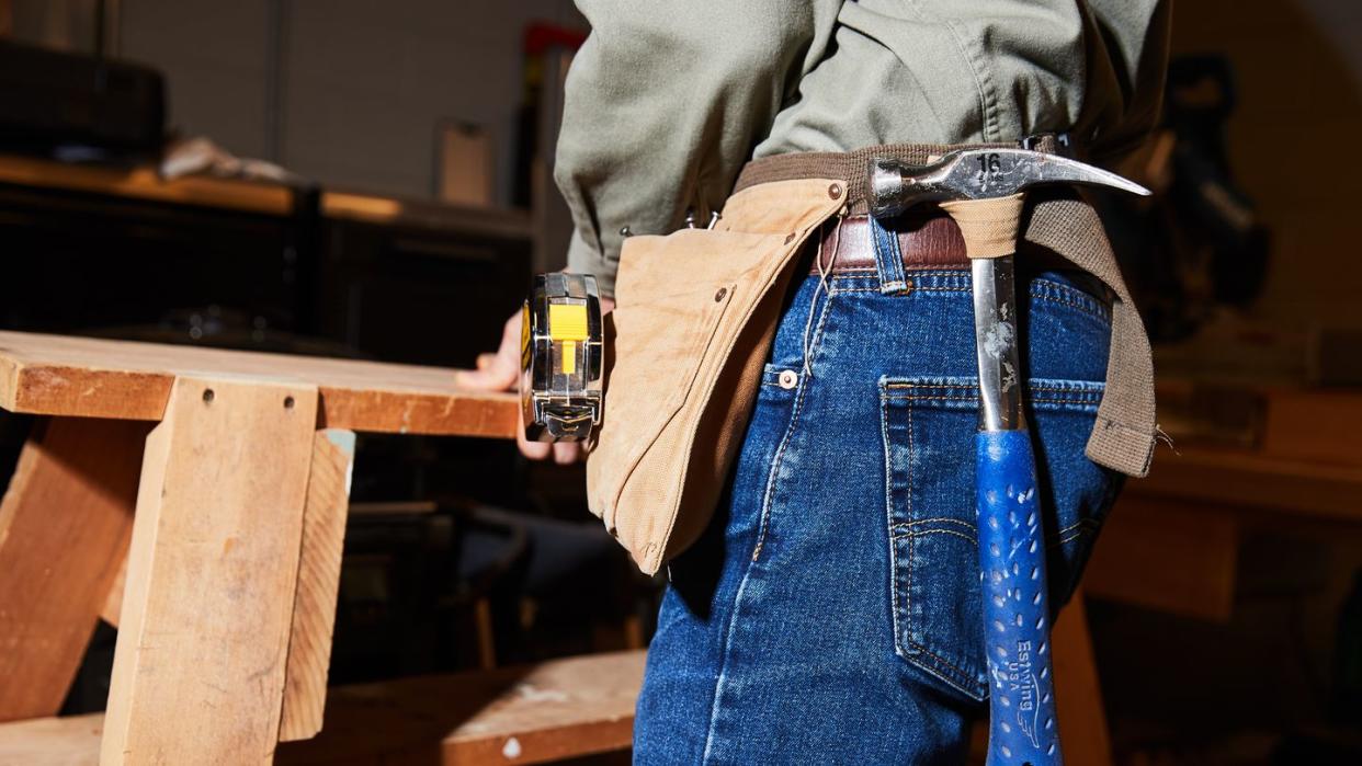 estwing hammer and tape measure hanging in tool belt