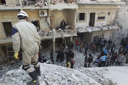 Residents search for survivors after what activists said were air strikes by forces loyal to Syria's President Bashar al-Assad in the Maysar neighbourhood of Aleppo December 28, 2013. REUTERS/Jalal Alhalabi