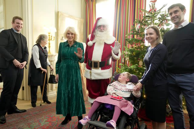 <p>Kin Cheung WPA Pool/Getty</p> Queen Camilla at the tree decorating event at Clarence House on Dec. 6.