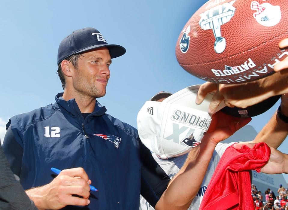 New England Patriots quarterback Tom Brady signs autographs during training camp at Gillette Stadium on Jul 30, 2016, in Foxborough, Massachusetts.